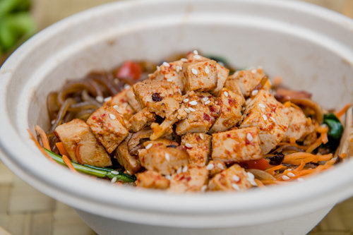 The Japchae dish is a pan-fried sweet potato noodles with shiitake mushrooms, bell peppers, spinach, carrots, sesame seeds and tofu from Old Capitol Food Company.