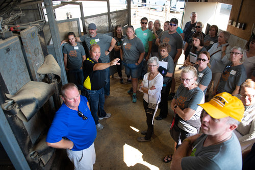 Marty and Steve Schwers tell the group about nutrition considerations and feed mixing. Photo credit: Joseph L. Murphy/Iowa Soybean Association