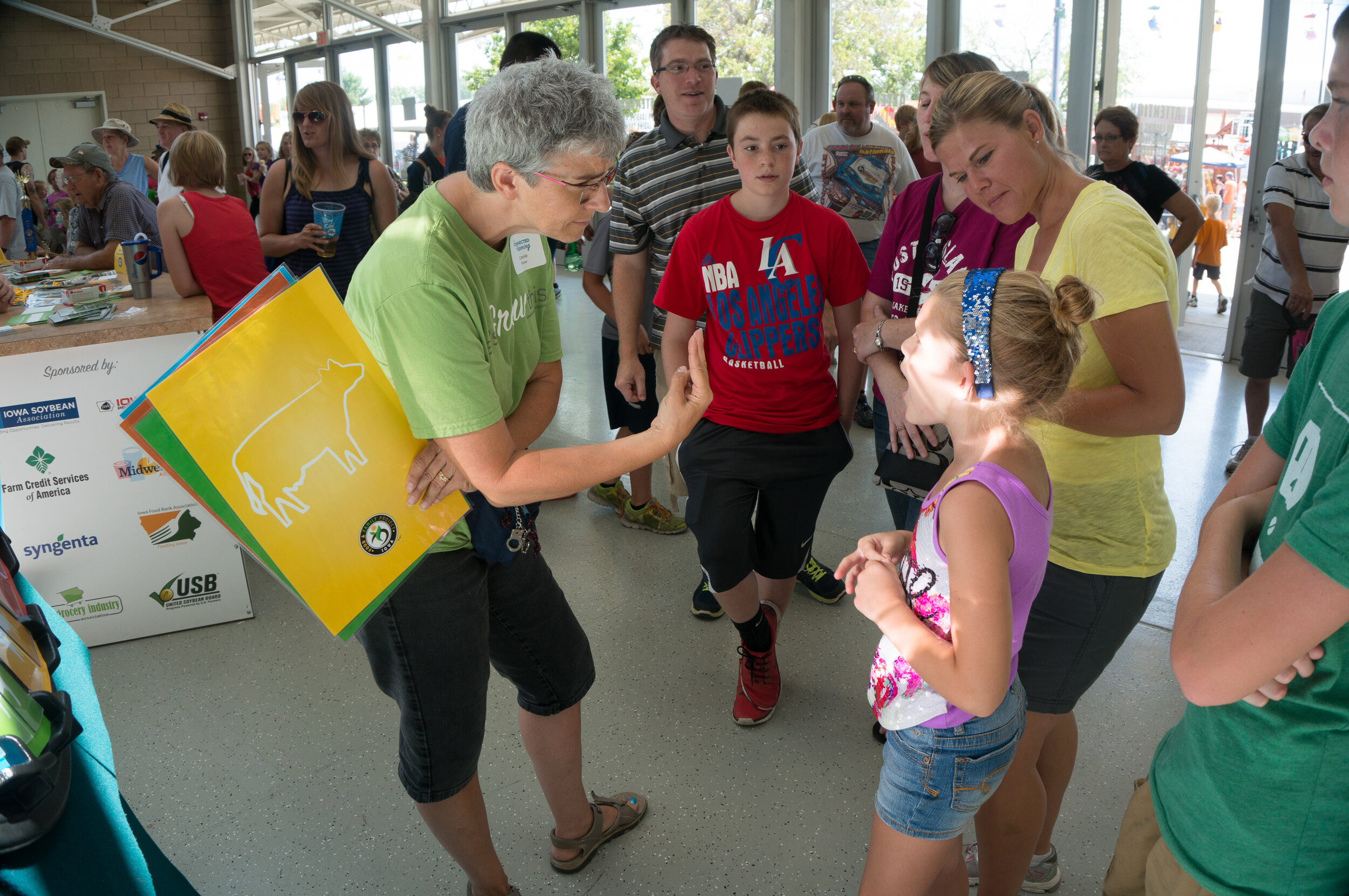 Fairgoers enjoy food and farming trivia at the Iowa FFP spin wheel.