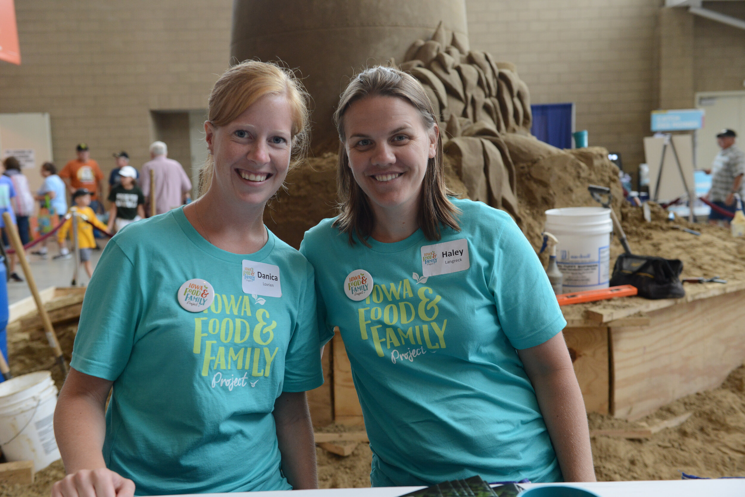 Volunteers pose with the Sandscape sculpture in 2016.