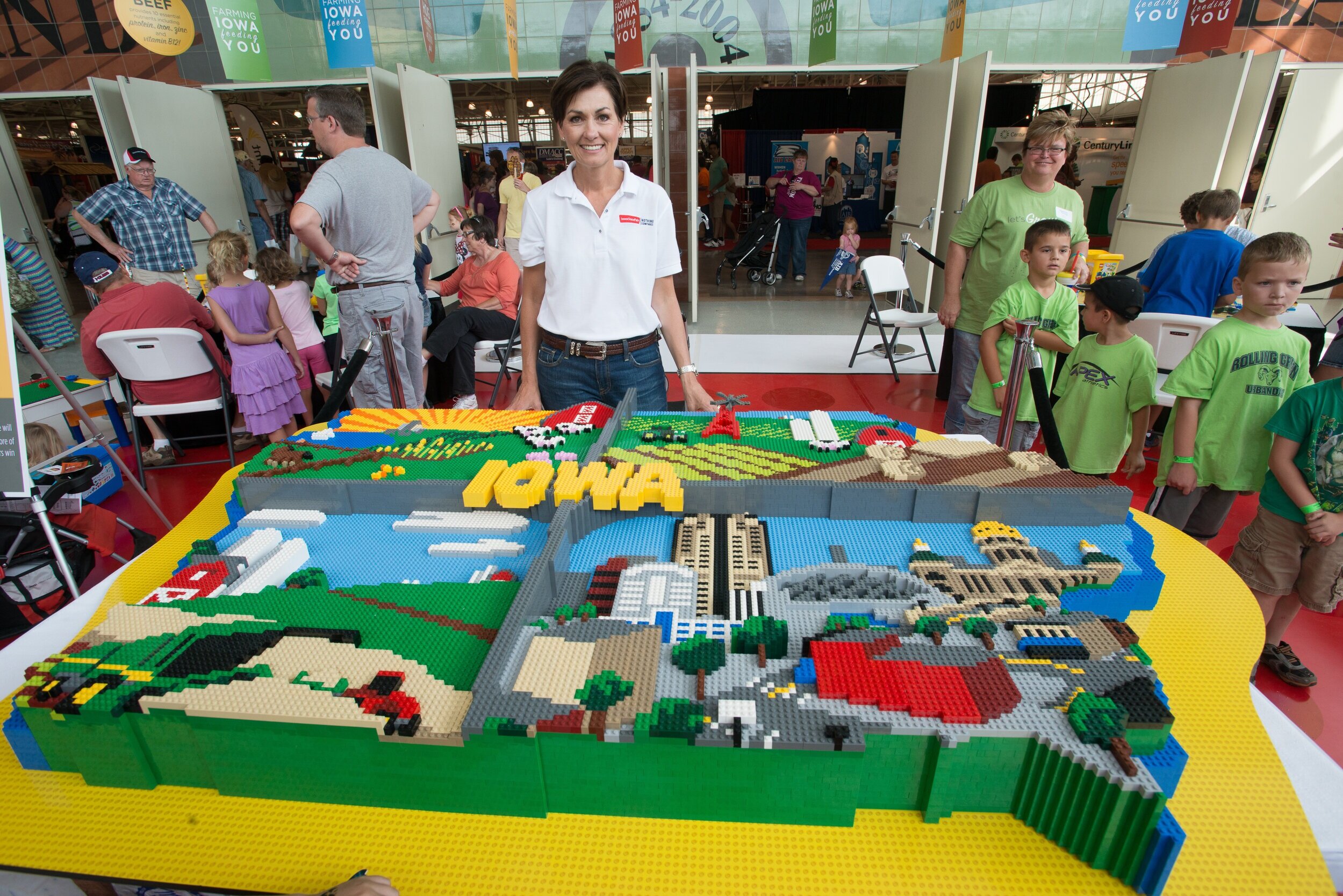 In 2013, the “Get Connected to Farming” display featured LEGO artwork built by a certified LEGO Professional. Governor Kim Reynolds poses for a picture with the Iowa LEGO artwork.