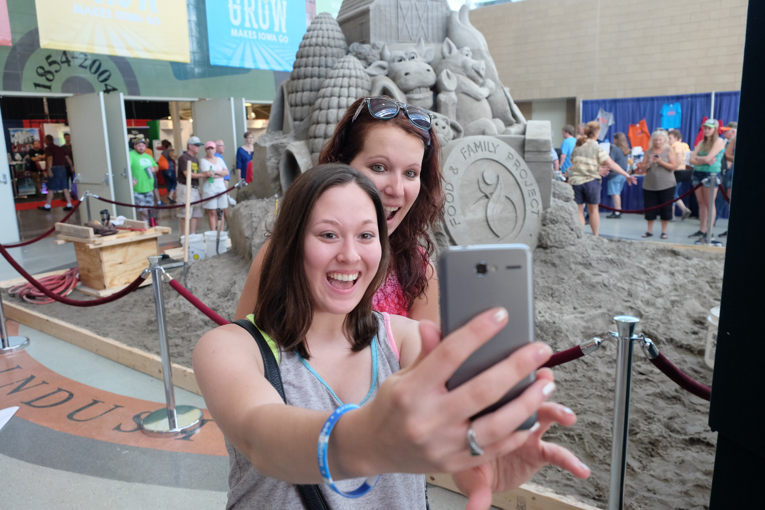 Fairgoers take a selfie with the Sandscape sculpture in 2014.