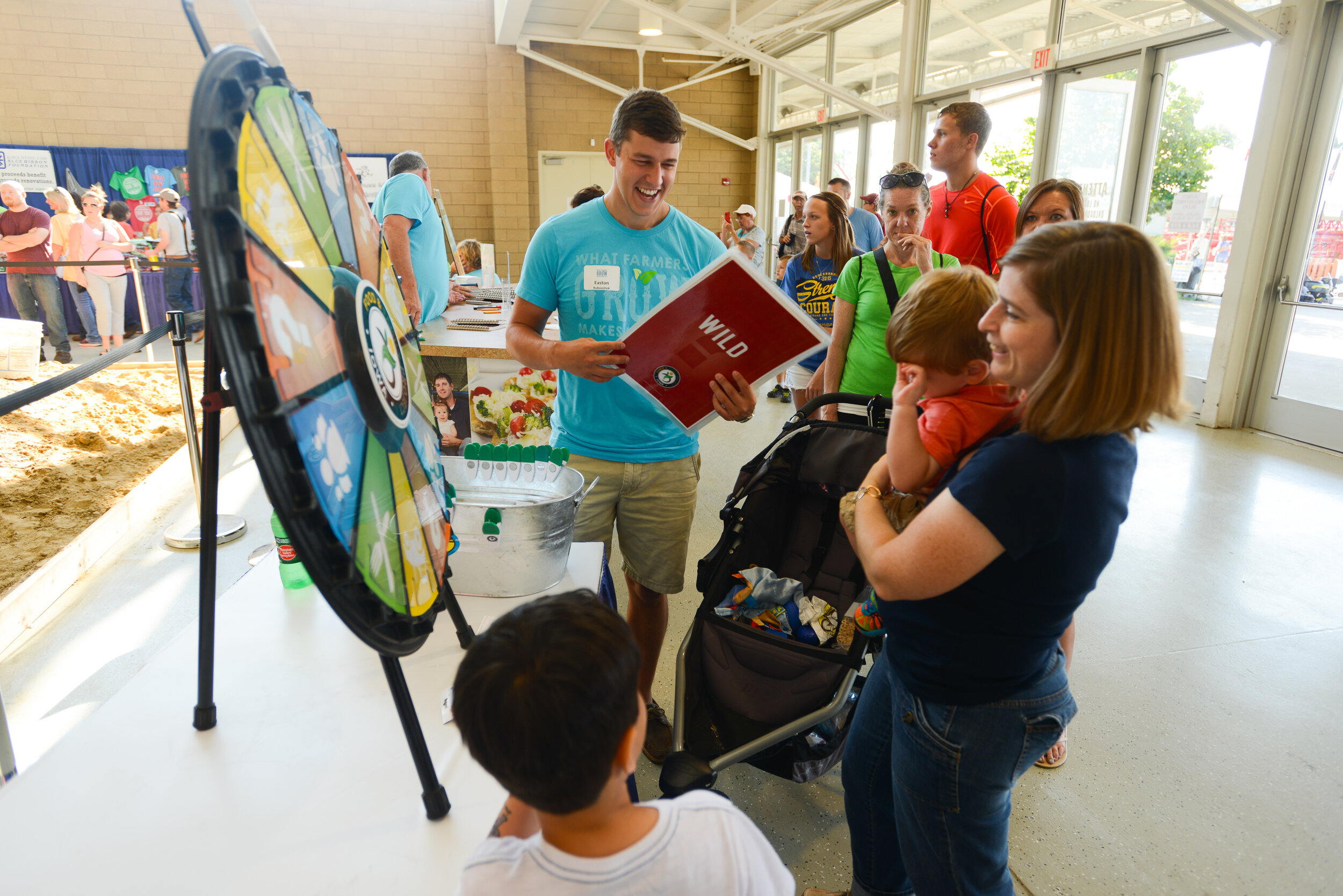 Fairgoers try their luck with the Iowa FFP trivia spin wheel during the 2015 fair.