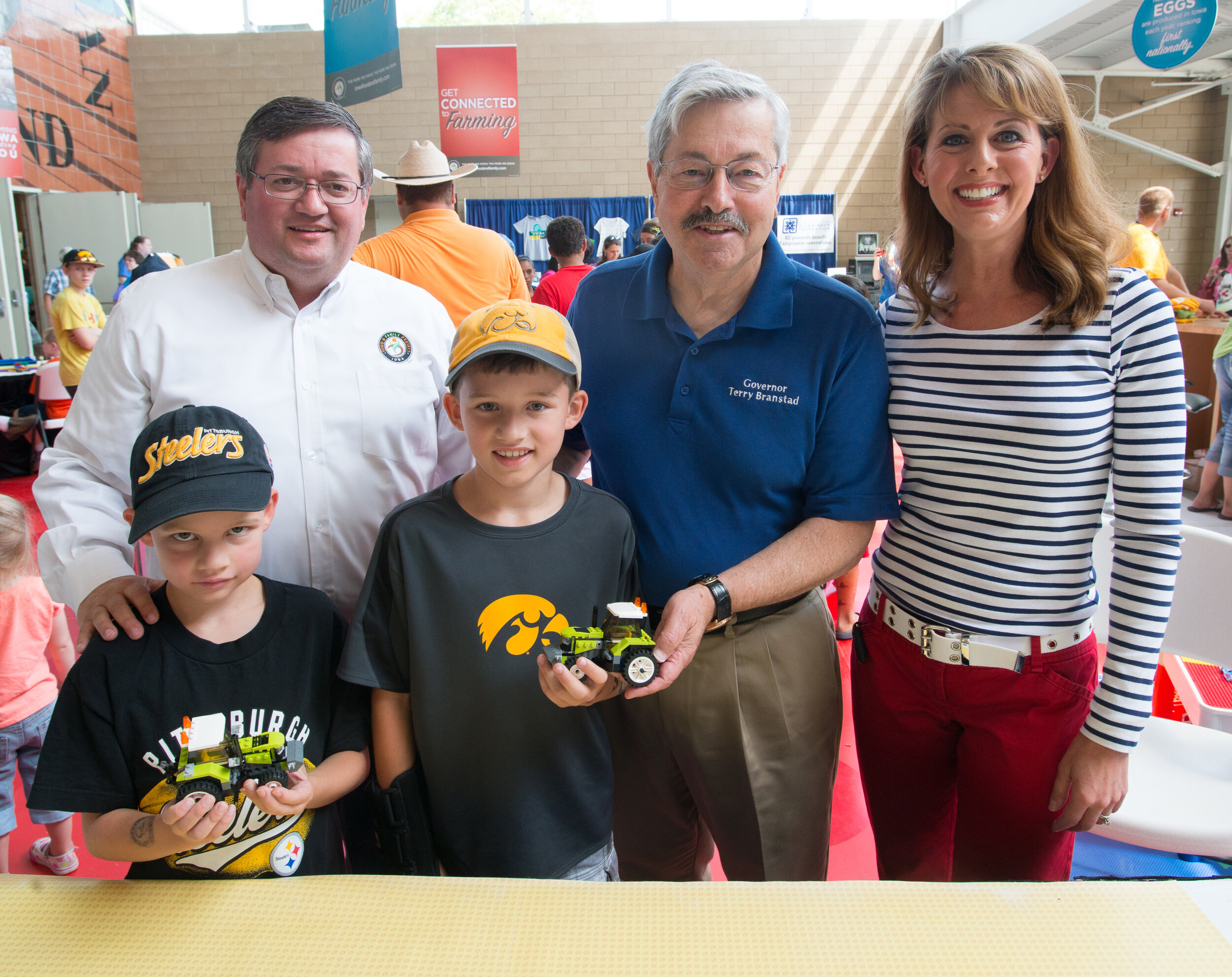 Local celebrities and fairgoers faced off in LEGO building challenges throughout the fair. Pictured is Iowa Soybean Association CEO Kirk Leeds, Ambassador Terry Branstad and Channel 13 News Anchor Erin Kiernan with Garrett and Grant Putze.