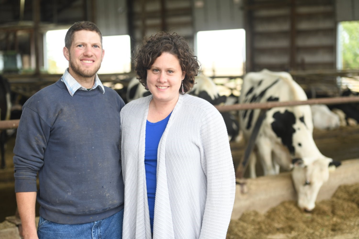 Lynn and Dan Bolin standing in front of dairy cows