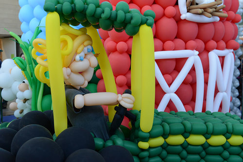 Balloon sculpture of farmer in tractor